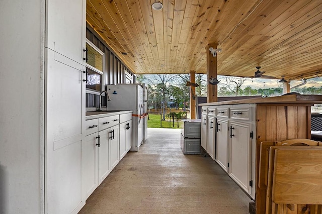 view of patio / terrace featuring a ceiling fan, a sink, and an outdoor kitchen