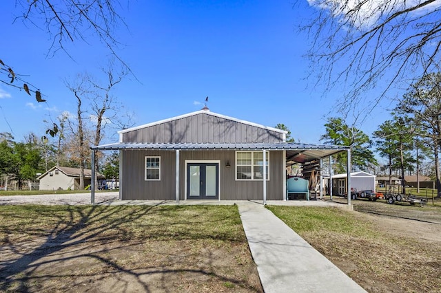 view of front of house featuring a carport and french doors