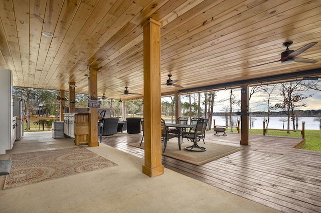 exterior space with outdoor dining area, a water view, and ceiling fan