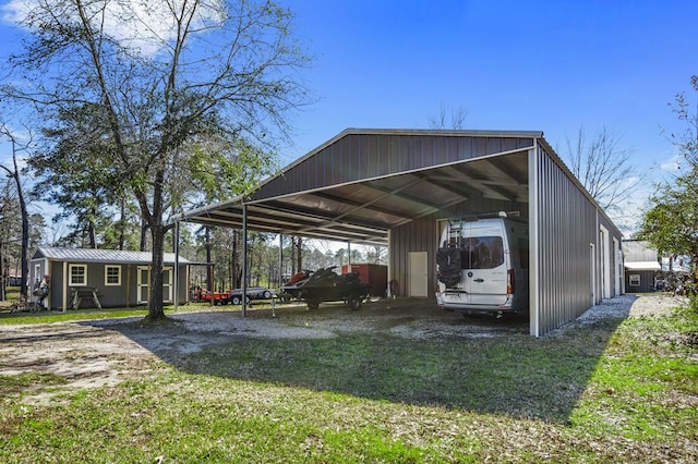 view of parking featuring a detached carport and driveway