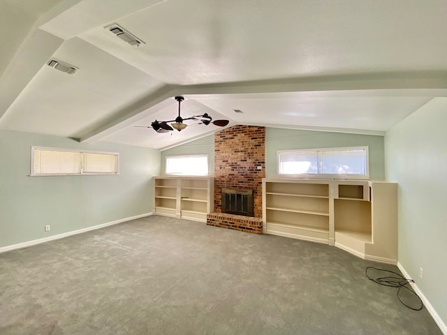 unfurnished living room with carpet, ceiling fan, plenty of natural light, and a fireplace