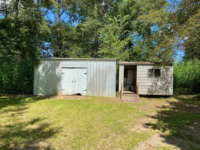 view of outbuilding with a lawn