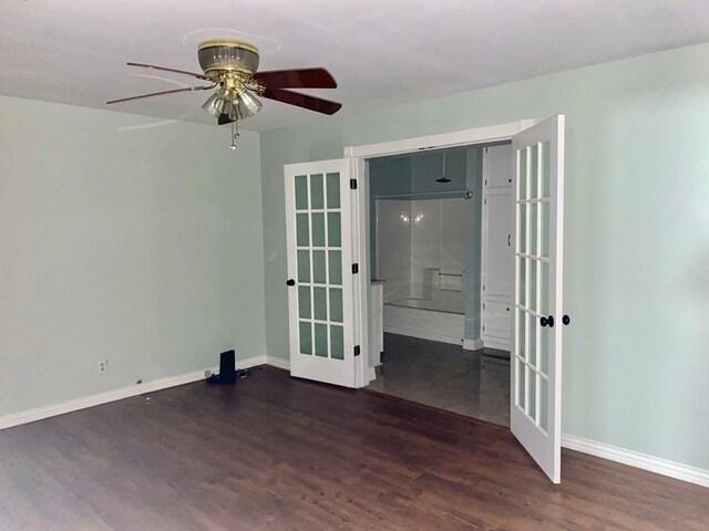 unfurnished room featuring ceiling fan, dark hardwood / wood-style flooring, and french doors