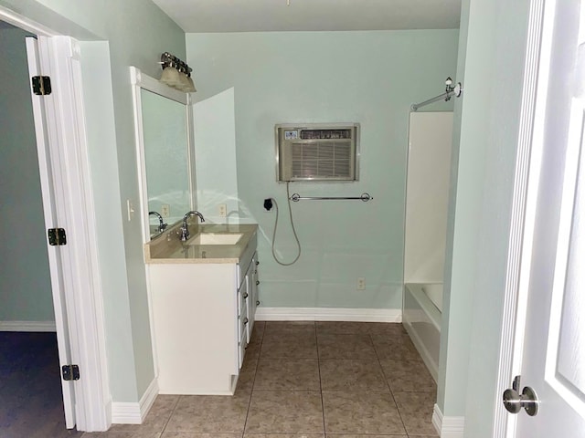 bathroom with tile patterned flooring, vanity, tub / shower combination, and a wall unit AC