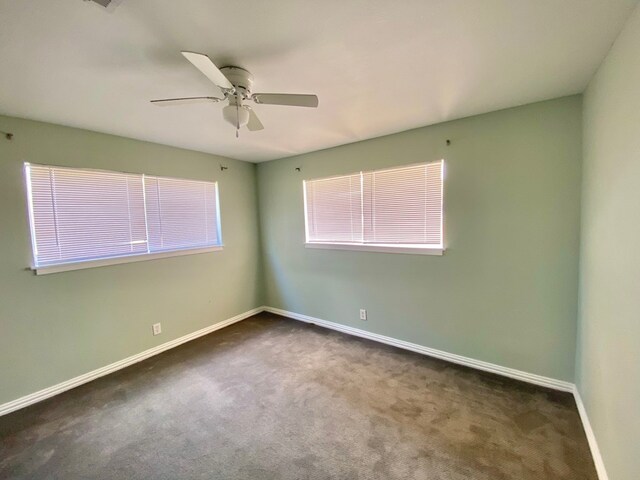 carpeted empty room featuring ceiling fan