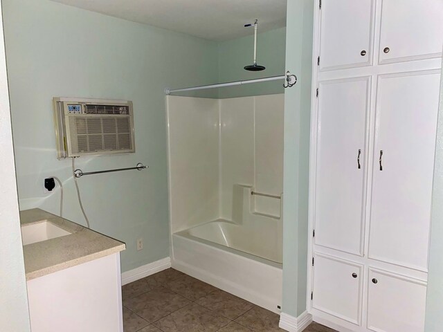 3759 Bethlehem Rd, Lufkin, TX 75904 - bathroom with baseboards, tile patterned floors, vanity, an AC wall unit, and a combined bath / shower with rainfall shower