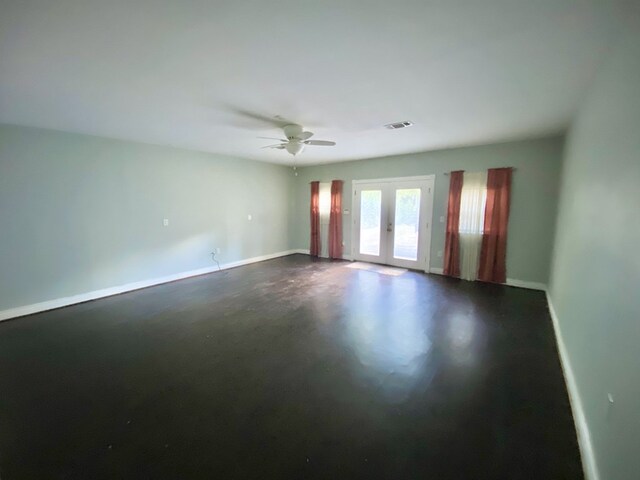 spare room featuring ceiling fan and french doors