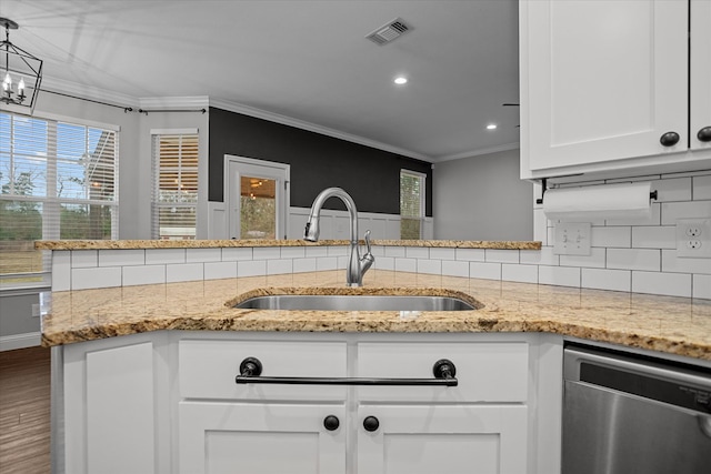 kitchen featuring visible vents, ornamental molding, a sink, white cabinets, and dishwasher