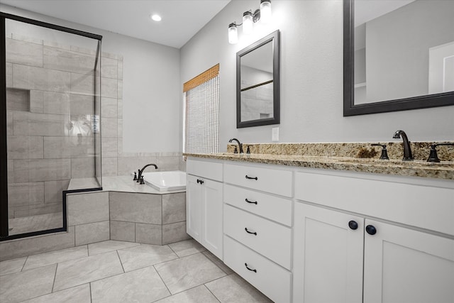 full bathroom featuring a sink, a bath, and a tile shower