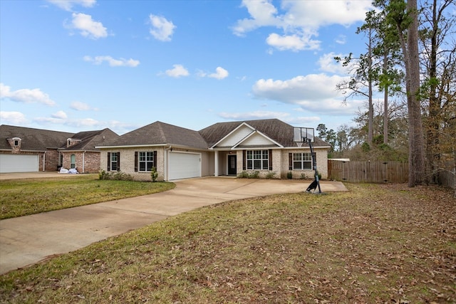 view of front of property featuring brick siding, a front lawn, fence, driveway, and an attached garage