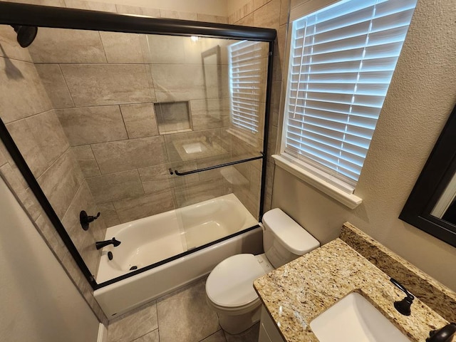 bathroom featuring combined bath / shower with glass door, toilet, and vanity