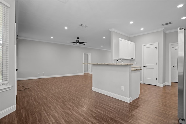 kitchen with visible vents, dark wood finished floors, ornamental molding, and white cabinetry