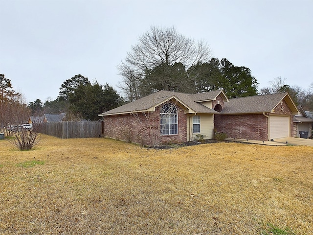 view of front of house with a garage and a front yard