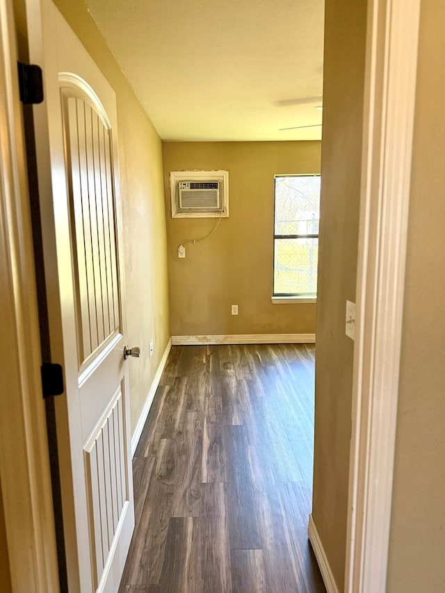 clothes washing area with dark hardwood / wood-style floors and a wall mounted AC