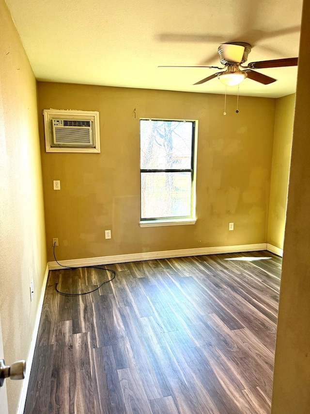 empty room featuring ceiling fan, dark hardwood / wood-style floors, and a wall unit AC