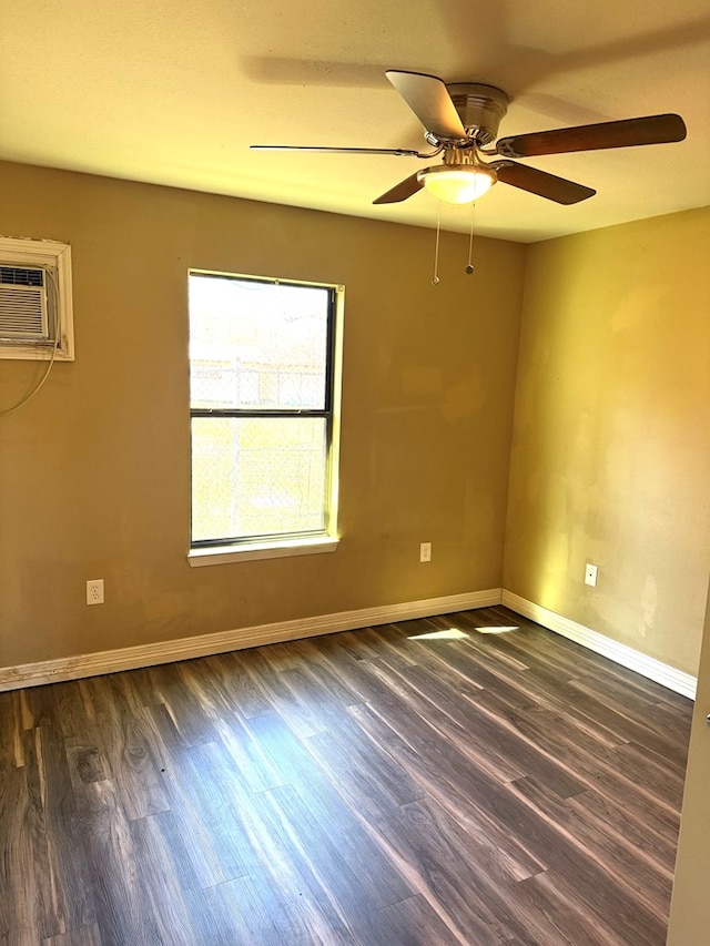 empty room featuring ceiling fan, a wall mounted AC, and dark hardwood / wood-style floors