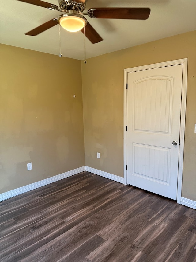 empty room with dark hardwood / wood-style floors