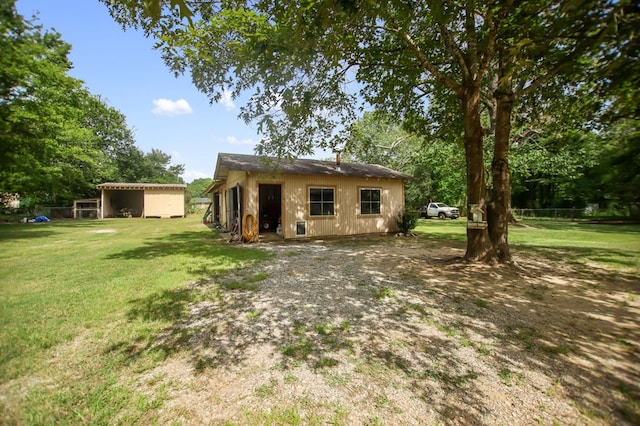 277 Mcclendon Rd, Lufkin, TX 75904 - rear view of property with a lawn and an outdoor structure
