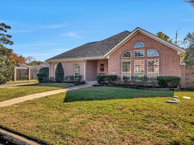 view of property featuring a front lawn