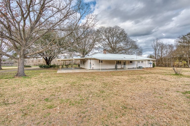 back of property with a lawn