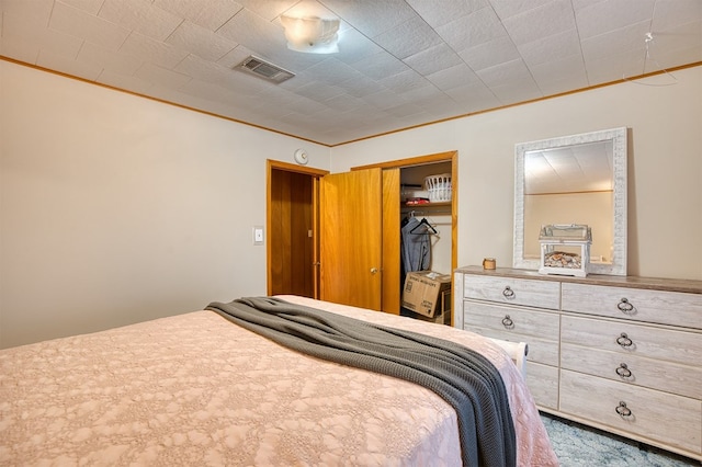 bedroom with ornamental molding and a closet