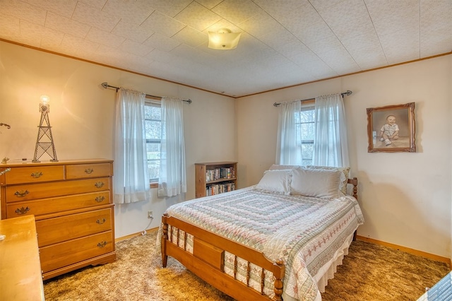 bedroom with multiple windows, crown molding, and carpet flooring