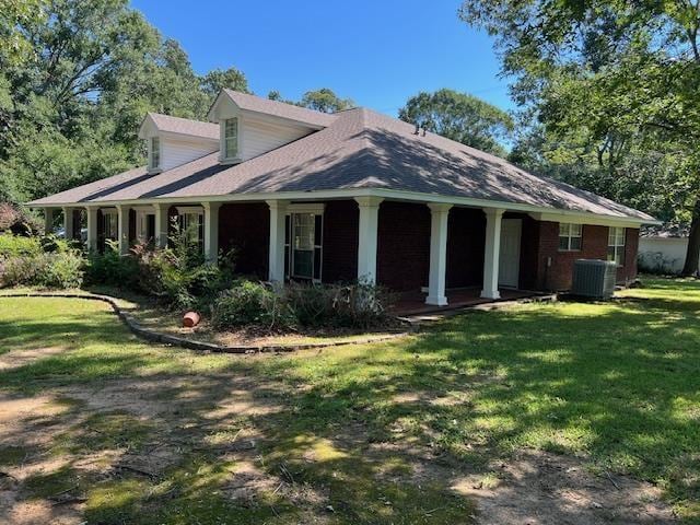 view of front of home with a front lawn and cooling unit