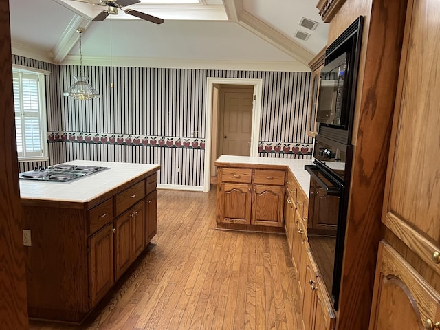 kitchen with ceiling fan, black appliances, tile countertops, light hardwood / wood-style floors, and lofted ceiling