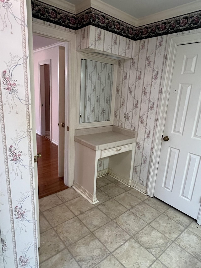 interior space featuring crown molding and light hardwood / wood-style flooring