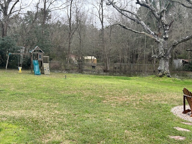 view of yard with a playground and fence