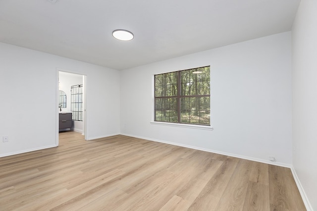 spare room with light hardwood / wood-style flooring