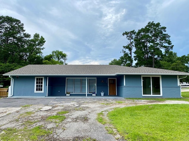 single story home featuring a front lawn