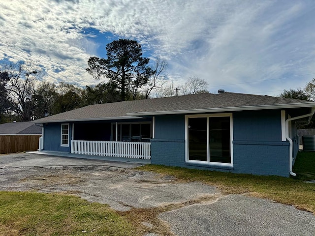 122 Otteson Ln, Lufkin, TX 75901 - view of front of property featuring a porch, brick siding, and roof with shingles