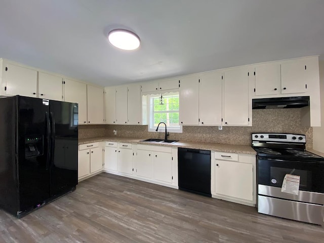 122 Otteson Ln, Lufkin, TX 75901 - kitchen featuring black appliances, ventilation hood, dark wood-style floors, tasteful backsplash, and light countertops