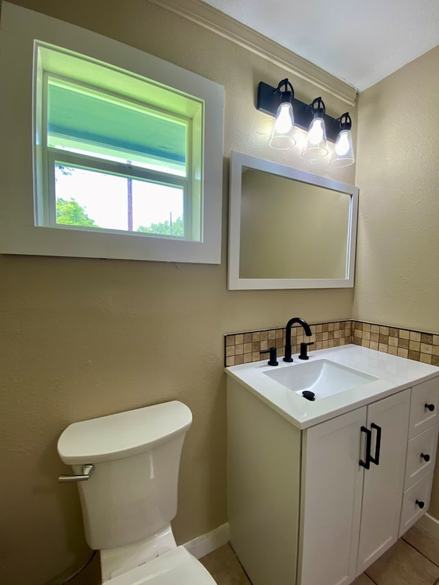 bathroom featuring decorative backsplash, tile patterned floors, vanity, and toilet