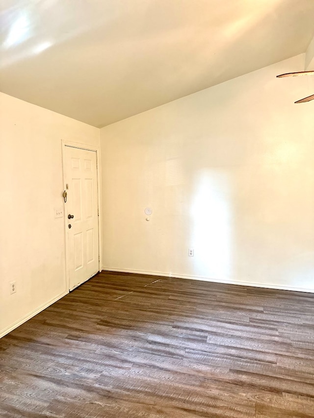 spare room with ceiling fan and dark hardwood / wood-style floors