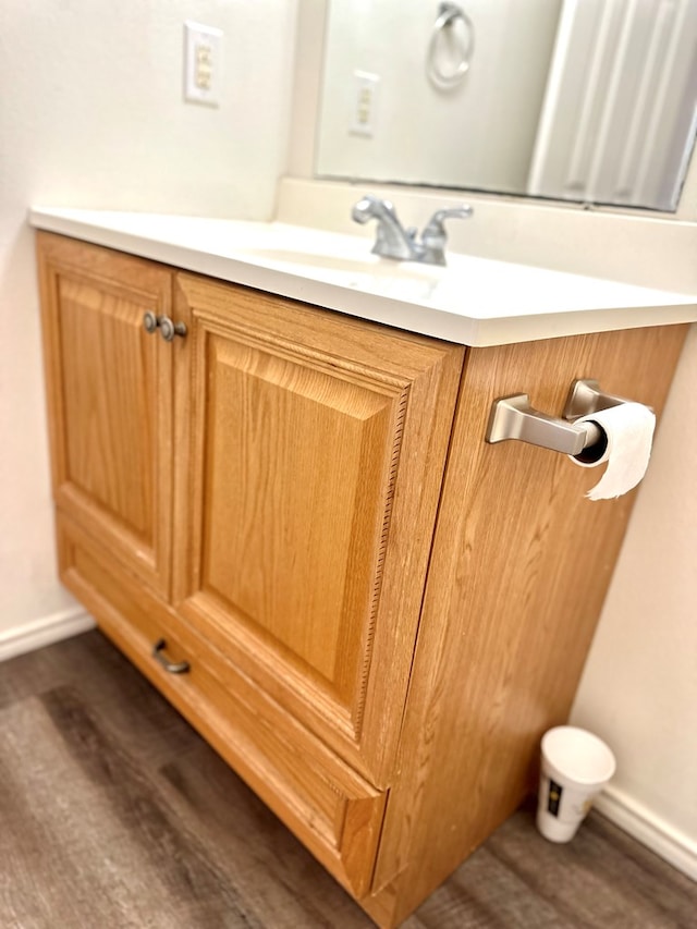 interior details with vanity and wood-type flooring