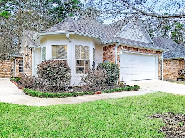 view of front of house with a front lawn and a garage