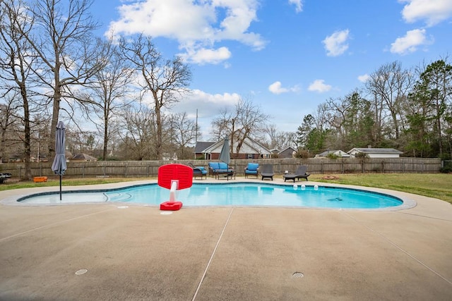 view of pool with a patio, a yard, a fenced in pool, and a fenced backyard