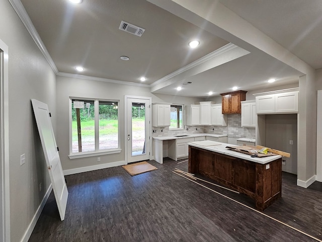 317 Shirey Ln, Lufkin, TX 75901 - kitchen with visible vents, a center island, dark wood-style floors, and ornamental molding