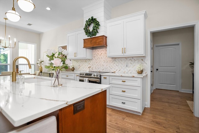217 Derek Rd, Lufkin, TX 75904 - kitchen with white cabinetry, a chandelier, stainless steel range with electric stovetop, decorative backsplash, and recessed lighting