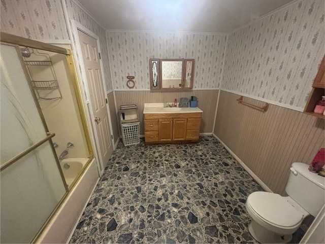 full bathroom featuring shower / bath combination with glass door, vanity, ornamental molding, and toilet