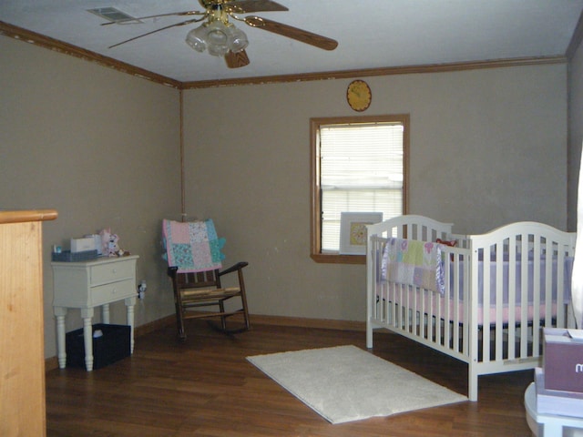 bedroom featuring ceiling fan, dark hardwood / wood-style flooring, and crown molding