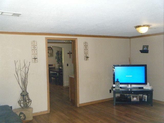 living room with dark hardwood / wood-style floors and crown molding