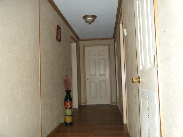 hallway featuring ornamental molding and dark wood-type flooring