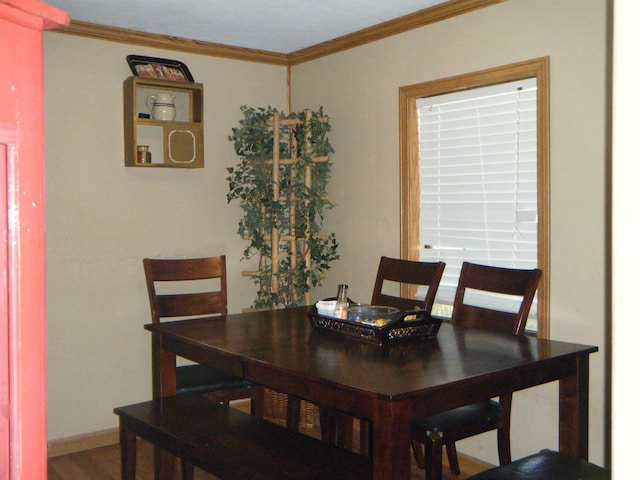 dining space featuring hardwood / wood-style floors and ornamental molding