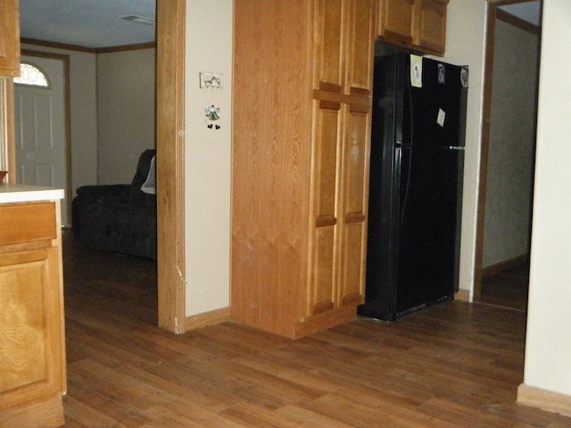 interior space featuring crown molding and dark hardwood / wood-style flooring