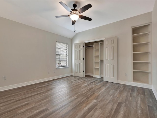 unfurnished bedroom featuring lofted ceiling, hardwood / wood-style floors, ceiling fan, and a closet