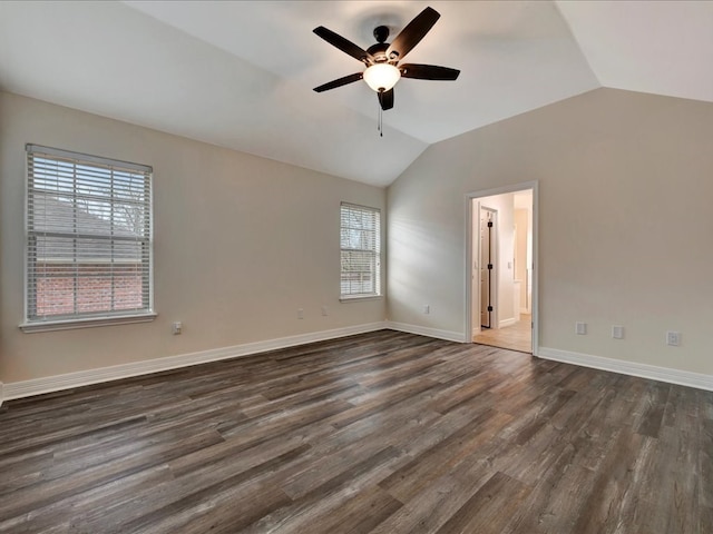 empty room featuring lofted ceiling, dark wood-type flooring, and ceiling fan