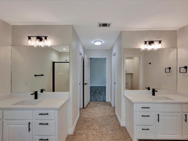 bathroom featuring vanity, tile patterned flooring, and walk in shower